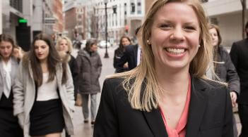students walk toward the camera smiling