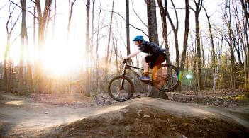 Student mountain biking on a trail