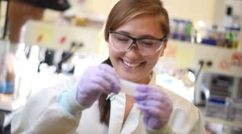 a student holds a tab in a lab