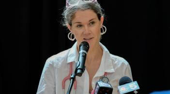 Woman Speaking at Microphone