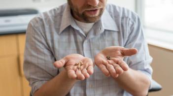 Eric Bishop von Wettberg holding different types of grain