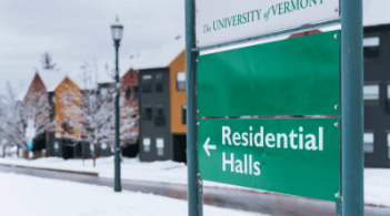 A sign that reads "Residential Halls" with buildings in the background.