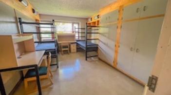 Residence hall room with two beds, two closets, and two desks.