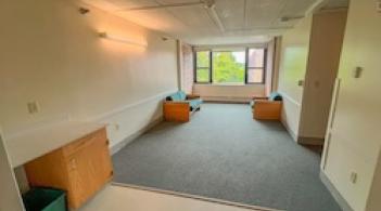 A room with two couches and a large window.