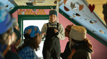 A trek leader directing a group of participants