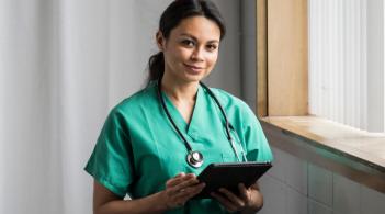 female doctor carrying a clipboard