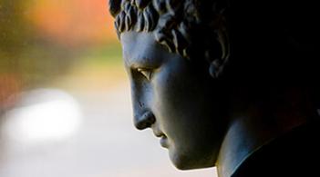 A bronze statue of a man's face