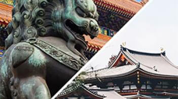 Chinese temple with lion statue in foreground
