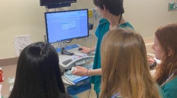 Nursing students view computer screen in simulation lab