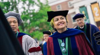 Person smiling in a graduation cap and gown