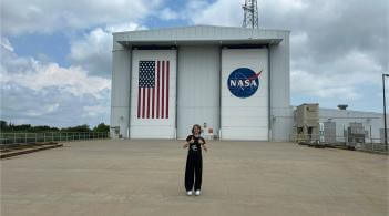 UVM student Addie Colwell smiles in front of Goddard Space Flight Center