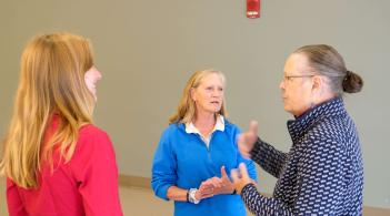 Student talking with two older women