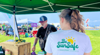 Be Sun Safe - UVM Cancer Center staff member under shade tent