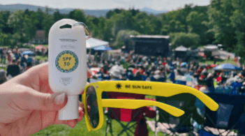 SPF 30 and a pair of sunglasses at outdoor event on a sunny day