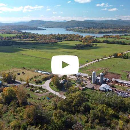 drone image of mountains, lakes, and farms