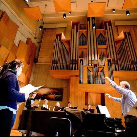 Students in choral practice at UVM's beautiful Recital Hall on the Redstone Campus