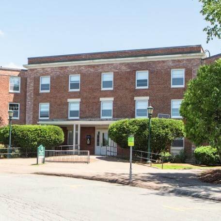 A three-story brick residence hall. 