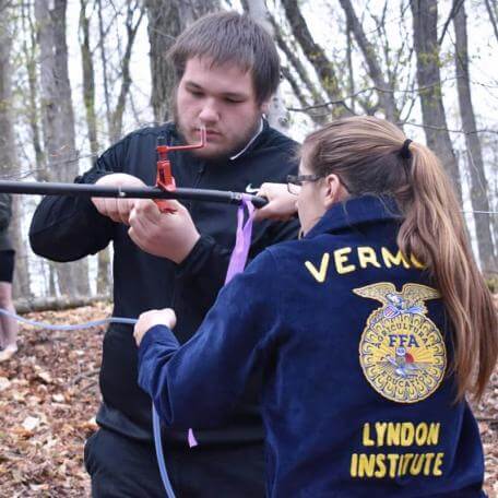 2 students outdoors working on maple tubing