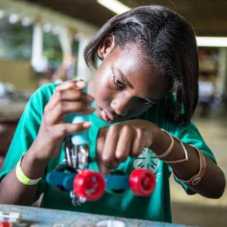 kid working on constructing a small robot