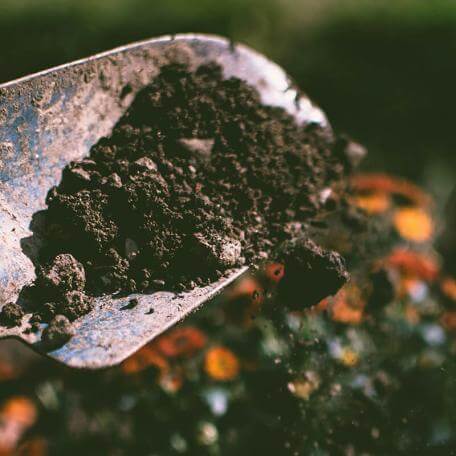 a garden tool filled with soil