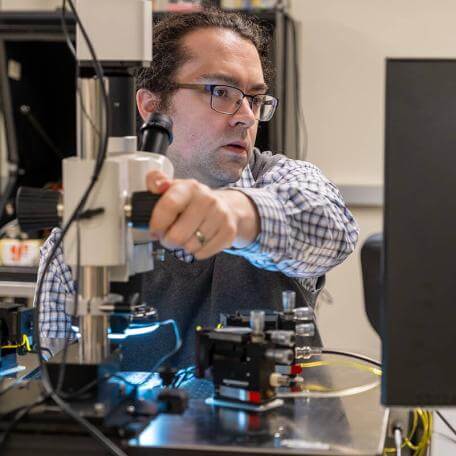 EE research professor Jackson Anderson adjusts equipment in the semiconductor lab