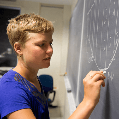 Student solving problem on the blackboard