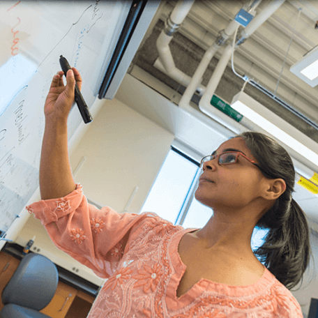 Physics graduate student at the white board