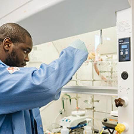 A man in a lab coat conducting experiments in a laboratory