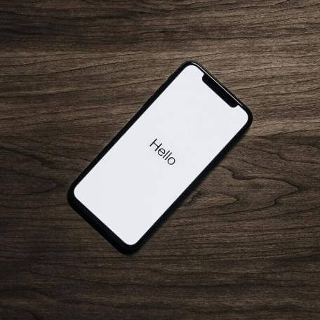 a smartphone displaying "hello" on a table