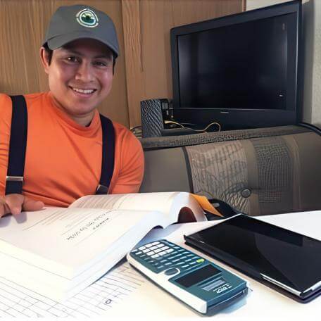 teenager at a table with a textbook and calculator
