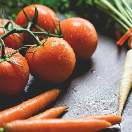 carrots and tomatoes on a table