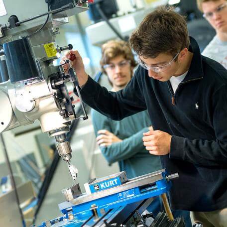 Students learning how to use the equipment in the CEMS machine shop
