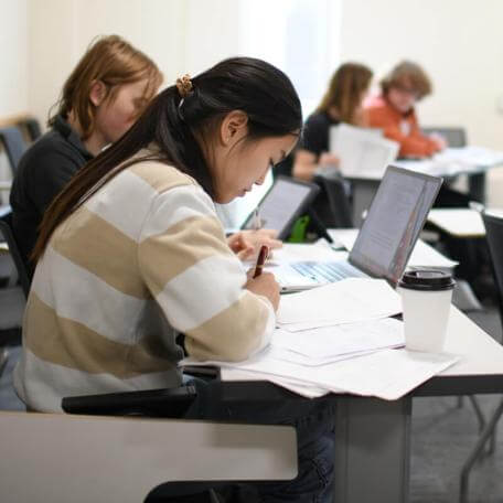 A few UVM students in a class working in pairs