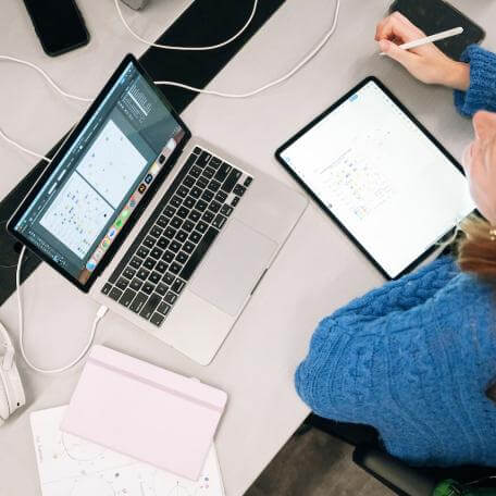 A student working on her laptop above view