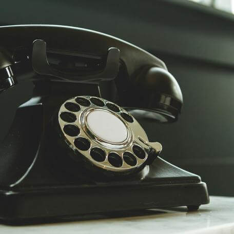 old rotary phone on a table