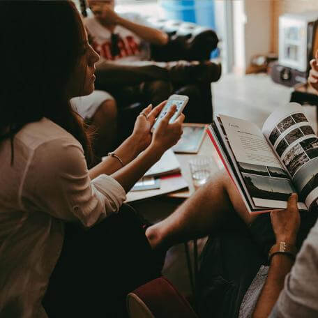 a small group of people sitting with each other indoors