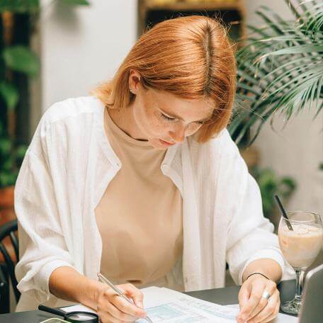 person at a desk looking down at some paperwork