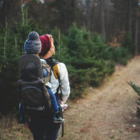parent and child hiking on a trail
