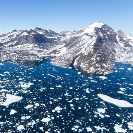 Link, Grey mountains with snow on them. Dark blue ice is in the foreground.