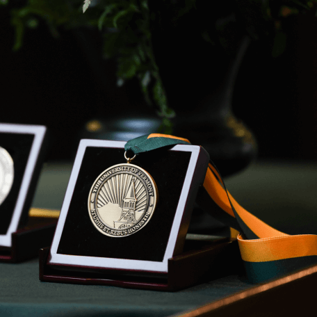 Award with ribbon on a table links to Center Accomplishments Page