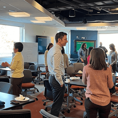 People standing in a room talking to each other