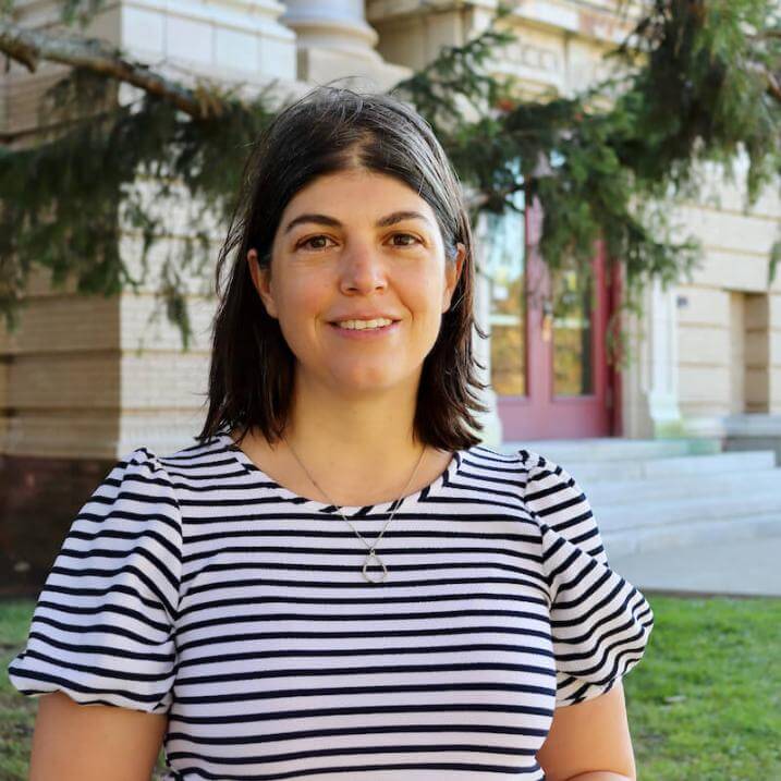 Jacqueline Drouin standing in front of a building