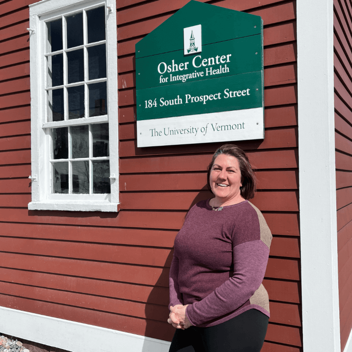 Cara Hancy in front of Osher Center sign