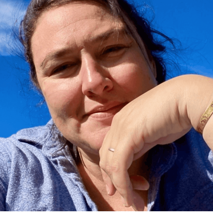 Ryun, sun shining on her smiling face with clouds and blue sky background