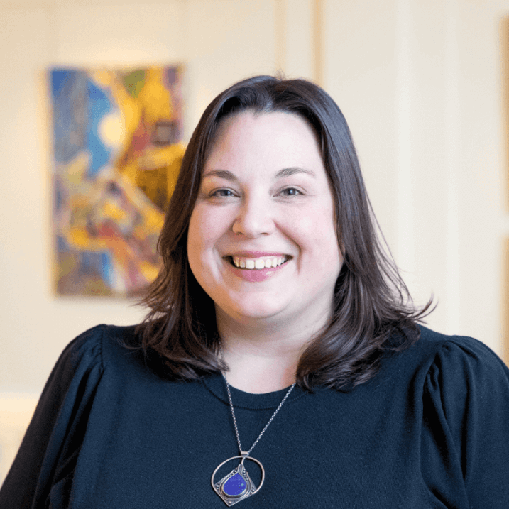Portrait of Rachel Moreau, she is smiling and wears a black sweater. 