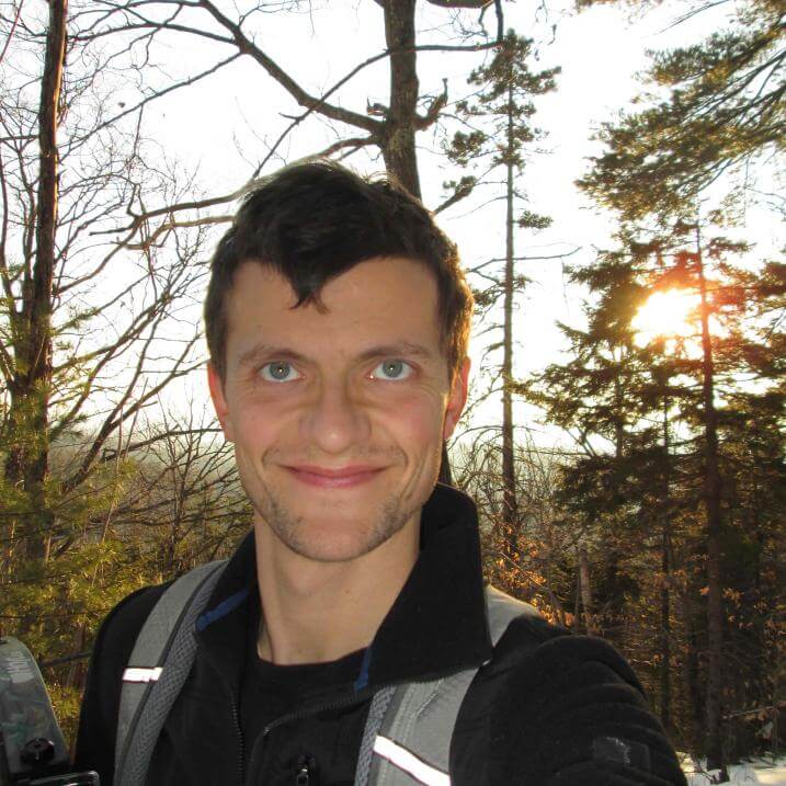 Headshot of Connor Stedman, with snowy woods in the background