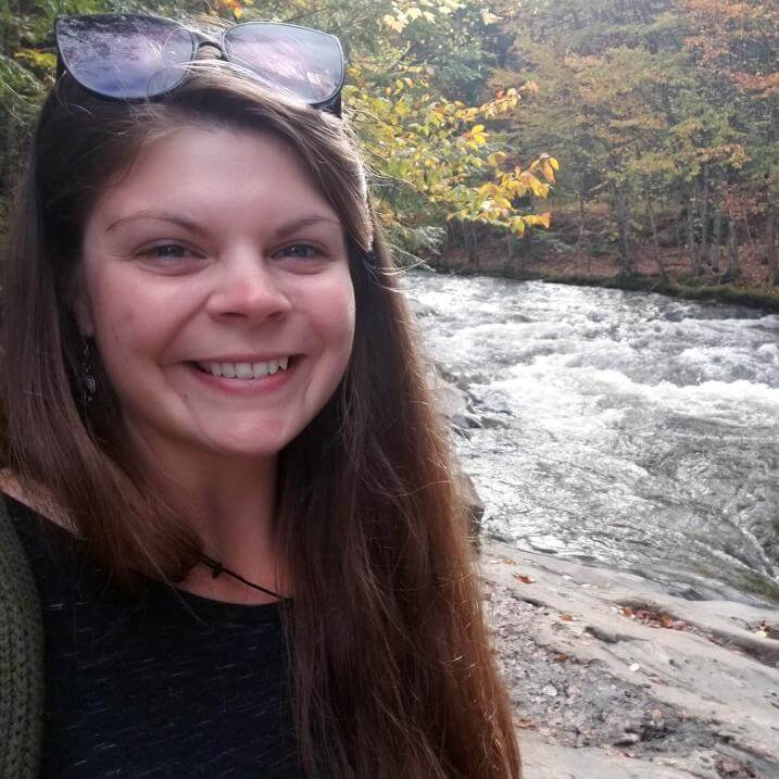Kellie Damann outdoors next to a river
