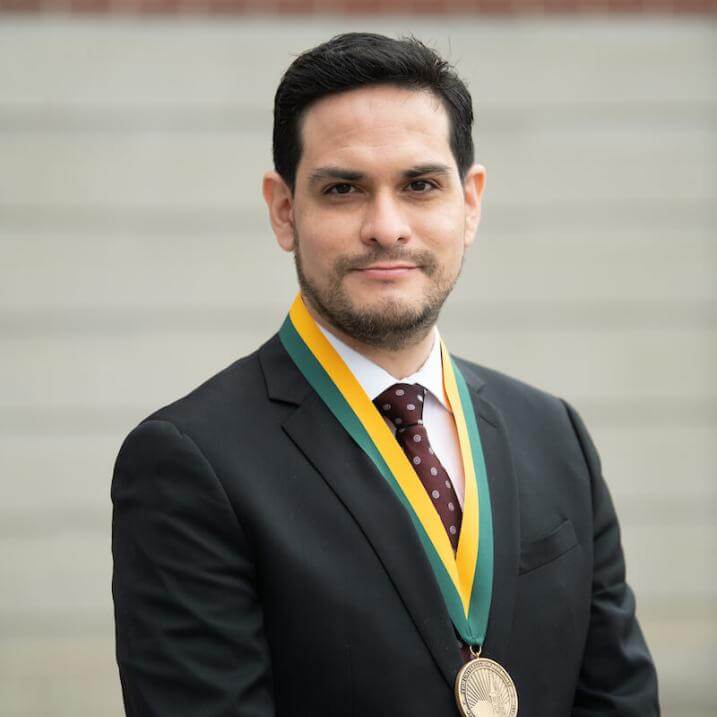 A person wearing black blazer and a medal 
