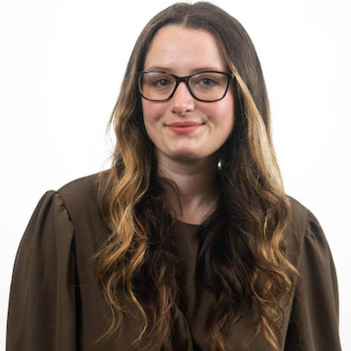 A person wearing a brown shirt and glasses