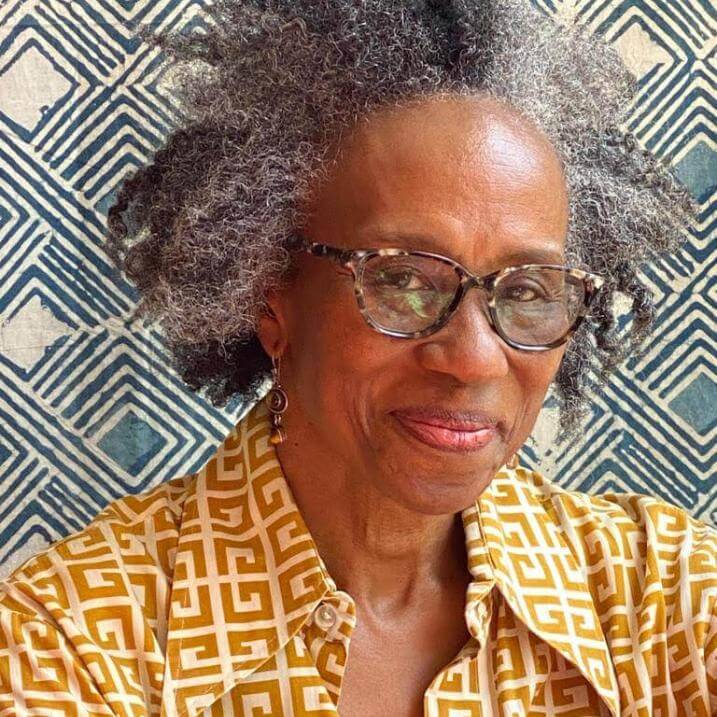 Headshot of Omi in from of indigo patterned fabric